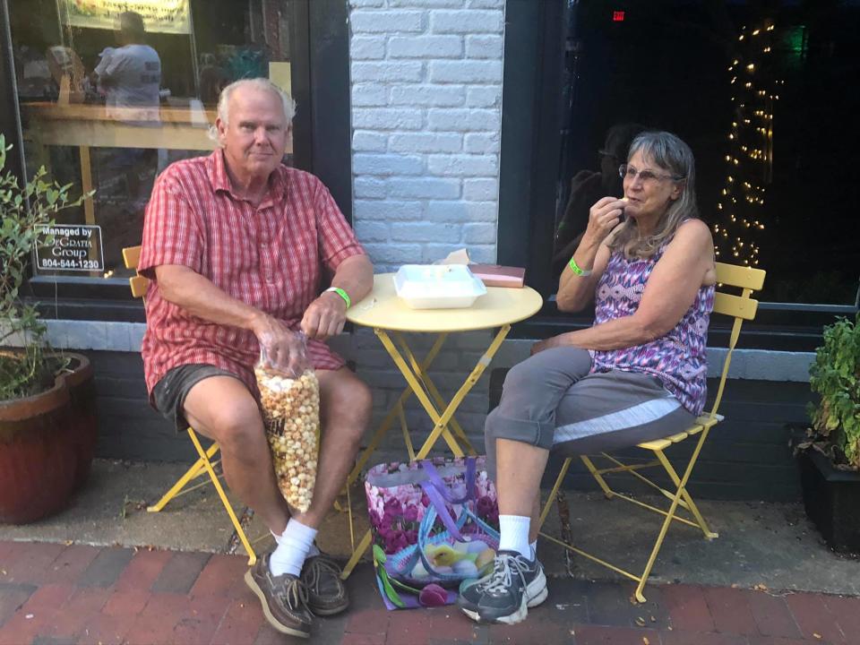 On the left, George Olsen and Janice Robertson both of Chester eat kettle corn at the 'Third Thursdays' street festival in Downtown Hopewell on September 16, 2021.