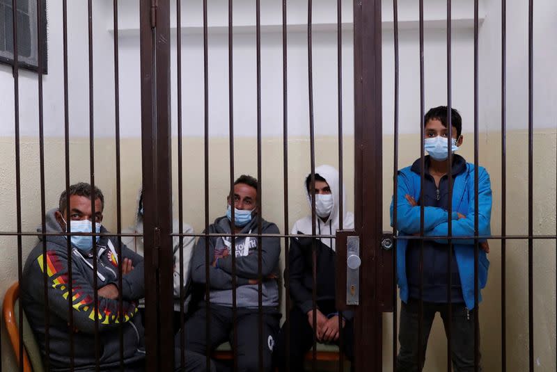 Migrants from Syria wait at a police registration centre in Nitra