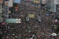 FILE - In this June 16, 2019, file photo, tens of thousands of protesters march through the streets as they continue to protest an extradition bill, in Hong Kong. Many in Hong Kong took to the streets in 2019 hoping to salvage rights of free speech and association denied to residents of mainland China, where public dissent is treated as subversive and punishable by long prison terms. (AP Photo/Vincent Yu, File)