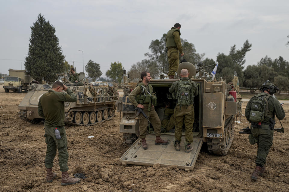 Israeli soldiers are seen at a staging area near the Israeli-Gaza border, in southern Israel, Thursday, Dec. 28, 2023. The army is battling Palestinian militants across Gaza in the war ignited by Hamas' Oct. 7 attack into Israel. (AP Photo/Ohad Zwigenberg)