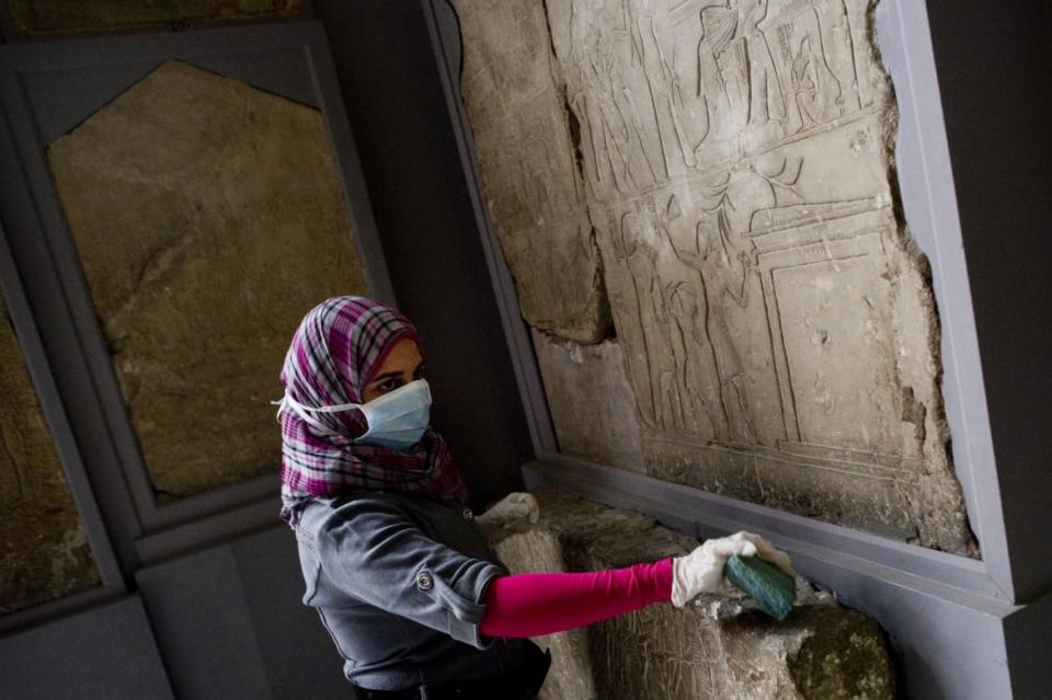 <div class="inline-image__caption"><p>"An Egyptian worker cleans some of the archeological pieces inside the Egyptian Museum on February 16, 2011. Looters broke into the museum in Cairo's Tahrir Square on January 28 when anti-Mubarak protesters drove his despised police from the streets in a series of clashes, shattering 13 display cases and at least 70 artifacts, some of which have been recovered and repaired according to Hawwas. Tutankhamun's mask was not taken or damaged by looters."</p></div> <div class="inline-image__credit">Pedro Ugarte/Getty</div>
