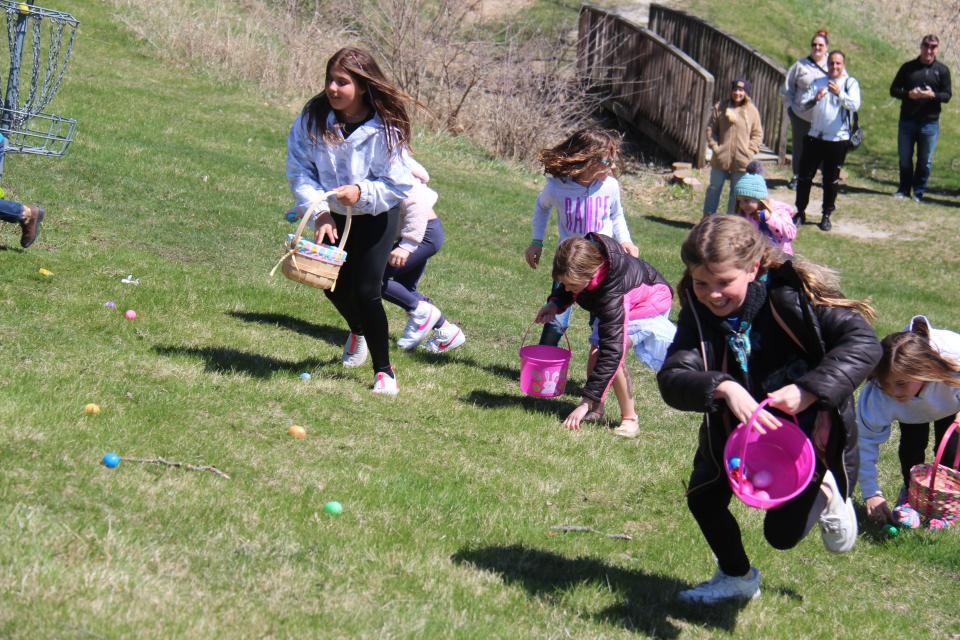 Kids race to pick up eggs and candy during the Van Meter Parks and Recreation Department's Easter egg hunt on Saturday, April 16, 2022, in Johnson Park.