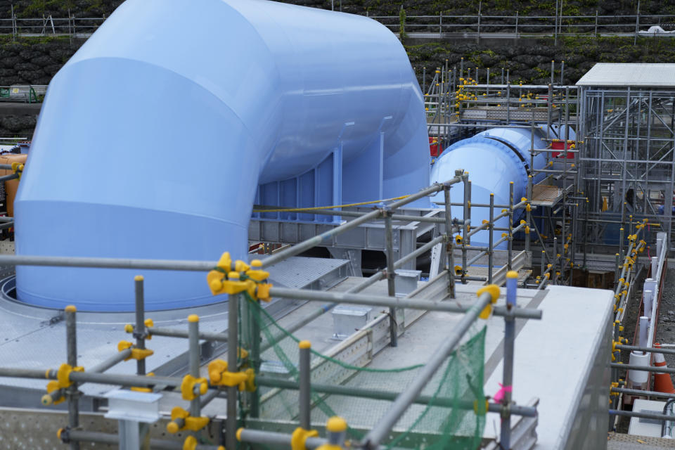 This photo taken during a tour for The Associated Press shows a blue pipeline to transport seawater, part of the facility for the release of treated radioactive water to sea from the Fukushima Daiichi nuclear power plant, operated by Tokyo Electric Power Company Holdings, also known as TEPCO, in Futaba town, northeastern Japan, Friday, July 14, 2023. (AP Photo/Hiro Komae)