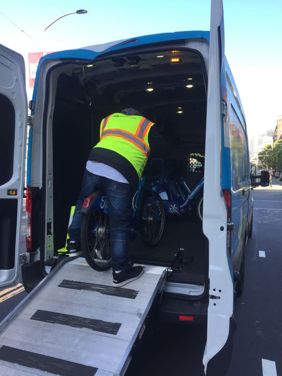 A field tech fills up the van with bicycles.