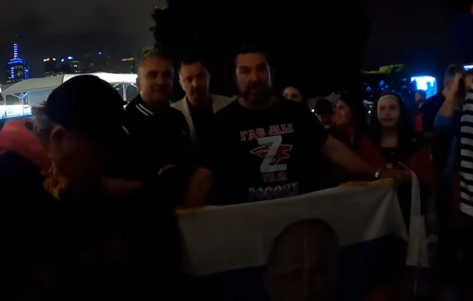 Srdjan Djokovic, left, poses with the crowd (Aussie Cossack Youtube)