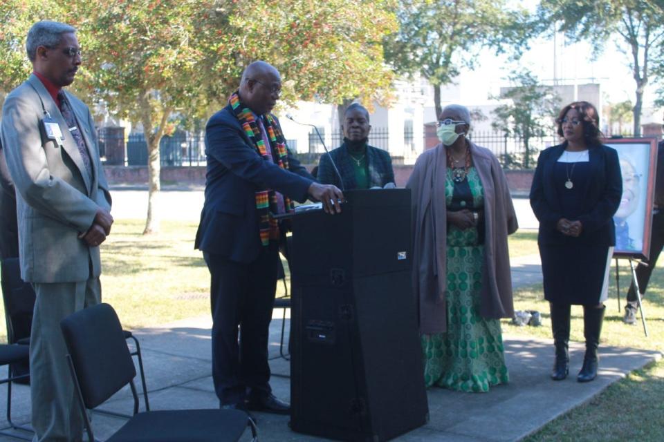 Kenneth Nunn, Ph.D., at the podium, shares a few remarks and a call to action after receiving a plaque on behalf of his late wife Patricia Hilliard-Nunn, Ph.D., for the work she has done for the Rosa Parks Quiet Courage Committee and the community at-large as a historian and community activist.