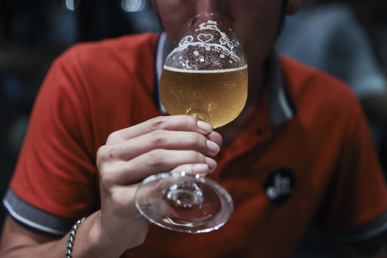 A customer drinks beer at a brewery in Bangkok. (Photographer: Chalinee Thirasupa/Bloomberg)