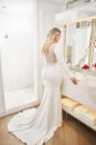 <p>Lawrence wears a long sleeve white gown with intricate lace details on the back by Justin Alexander. (Photo: courtesy of Justin Alexander) </p>