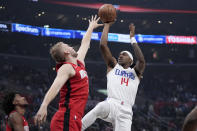 Los Angeles Clippers guard Terance Mann, right, shoots as Houston Rockets center Jock Landale defends during the first half of an NBA basketball game Sunday, April 14, 2024, in Los Angeles. (AP Photo/Mark J. Terrill)