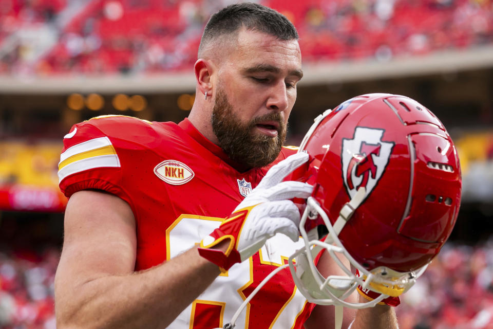 Kansas City Chiefs tightend Travis Kelce (87) dons his helmet during an NFL football game against the Las Vegas Raiders Monday, Dec. 25, 2023, in Kansas City, Mo. (AP Photo/Nick Tre. Smith)