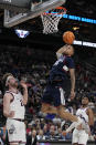 UConn guard Jordan Hawkins goes up for a shot against Gonzaga forward Drew Timme (2), left, in the second half of an Elite 8 college basketball game in the West Region final of the NCAA Tournament, Saturday, March 25, 2023, in Las Vegas. (AP Photo/John Locher)