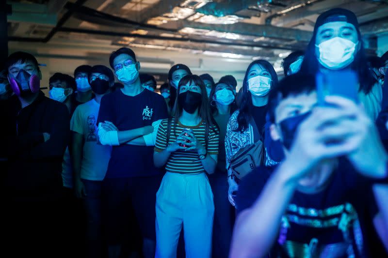 Fans wearing protective masks enjoy a band's performance at Hidden Agenda: This Town Needs (TNN) Live House during the club's last concert as business plummets due to the fear of the coronavirus, in Hong Kong