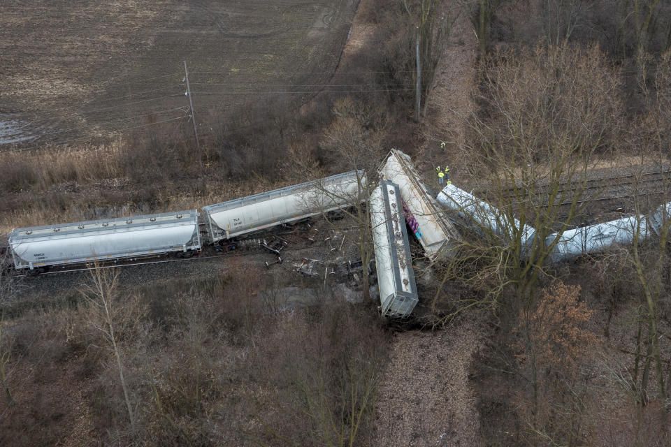 An emergency crew works at the site of a Norfolk Southern train derailment in Van Buren Township, Mich., near Detroit, on Thursday, Feb. 16, 2023. (Andy Morrison/Detroit News via AP)