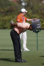 Tiger Woods stretches on the second fairway during the first round of the PNC Championship golf tournament Saturday, Dec. 18, 2021, in Orlando, Fla. (AP Photo/Scott Audette)