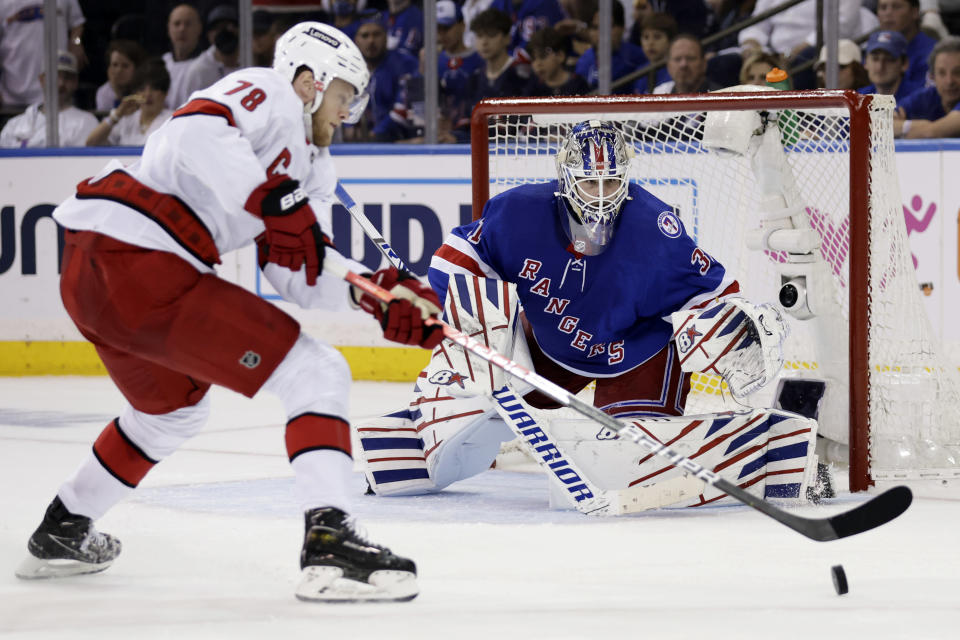 New York Rangers goaltender Igor Shesterkin, right, defends against Carolina Hurricanes center Steven Lorentz (78) during the second period of Game 3 of an NHL hockey Stanley Cup second-round playoff series, Sunday, May 22, 2022, in New York. (AP Photo/Adam Hunger)