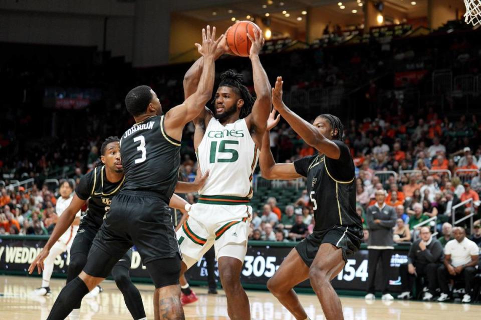 UM’s Norchad Omier is triple-teamed as he looks to pass during the Hurricanes’ game Friday night against Central Florida.