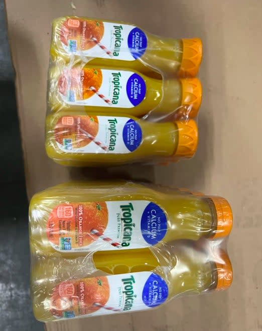 Tropicana orange juice bottle packaging is displayed on a surface.  There is no visible text other than product labels