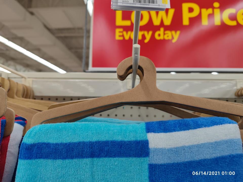 a cardboard hanger in a store with a towerl on it