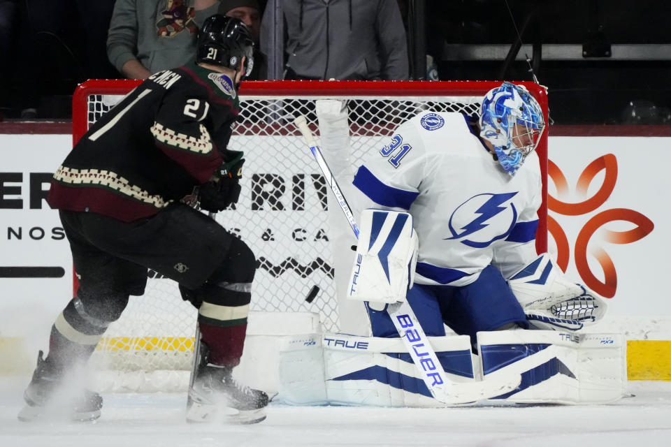 Tampa Bay Lightning goaltender Jonas Johansson (31) gives up a goal to Arizona Coyotes' Travis Boyd as Coyotes left wing Milos Kelemen (21) looks on during the second period of an NHL hockey game Tuesday, Nov. 28, 2023, in Tempe, Ariz. (AP Photo/Ross D. Franklin)