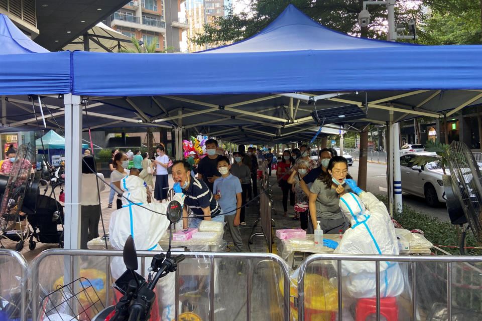 Medical workers in protective suits collect swabs from residents at a nucleic acid testing site following the coronavirus disease (COVID-19) outbreak in Shenzhen, Guangdong province, China July 23, 2022. REUTERS/David Kirton