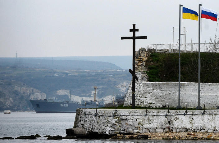 The Russian and a Ukranian flag fly in the port of Sevastopol on March 8, 2014. The Organization for Security and Co-operation in Europe said its monitors would try again on March 8 to enter the Ukrainian region of Crimea, two days after being prevented from doing so. On March 6 the Vienna-based OSCE said that its team had been prevented from entering Ukraine's strategic Black Sea peninsula, with a Western diplomatic source telling AFP they were turned back by gunmen.  AFP PHOTO / FILIPPO MONTEFORTE        (Photo credit should read FILIPPO MONTEFORTE/AFP via Getty Images)