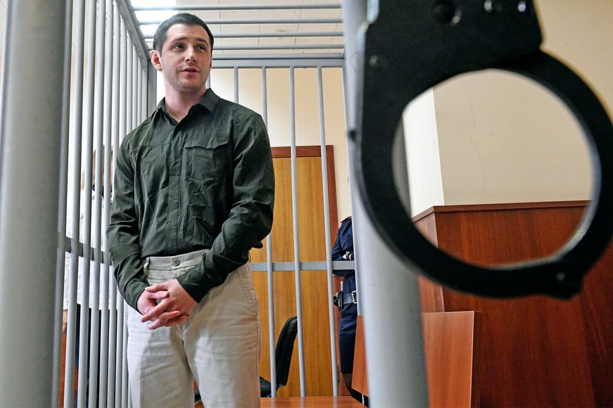 US ex-marine Trevor Reed, charged with attacking police, stands inside a defendants' cage during a court hearing in Moscow on March 11, 2020. (Photo by Alexander NEMENOV / AFP) (Photo by ALEXANDER NEMENOV/AFP via Getty Images)