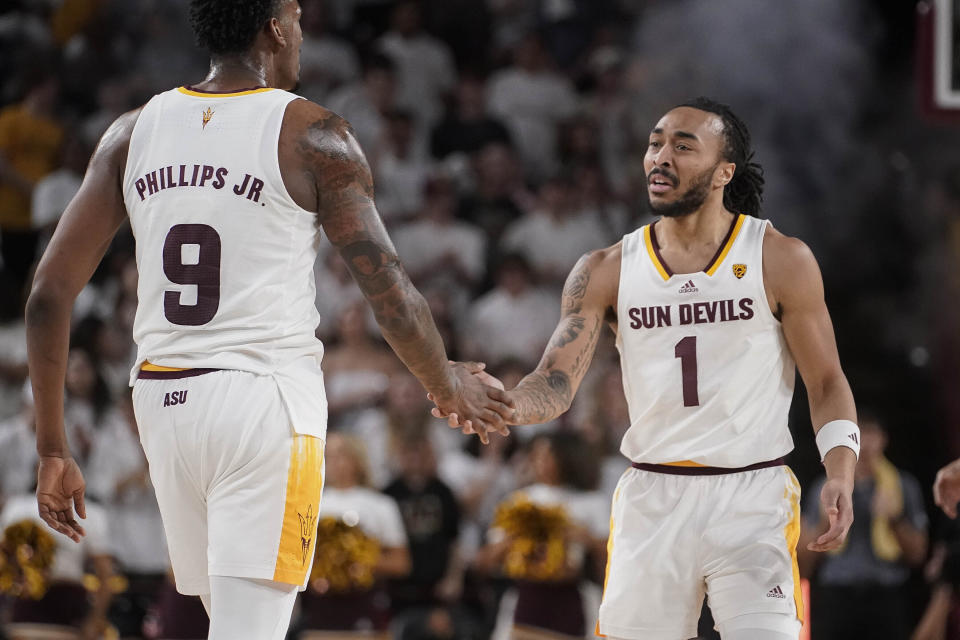 Arizona State center Shawn Phillips Jr. (9) slaps hands with guard Frankie Collins (1) after Collins hit a 3-pointer against Washington State during the first half of an NCAA college basketball game Saturday, Feb. 24, 2024, in Tempe, Ariz. (AP Photo/Darryl Webb)