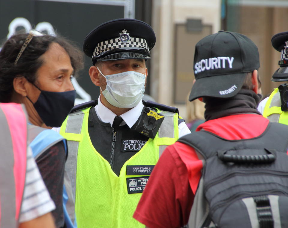  Police officer wearing a face mask as he listens to a protester. A change in policy has meant that in some situations where social distancing is impossible, Police at demonstrations will wear Protective face masks. A spokesperson said: "If officers cannot maintain a two metre gap and where there is a possible risk of infection, our policy is now that officers will wear a facemask, which all officers have readily available." (Photo by Keith Mayhew / SOPA Images/Sipa USA) 