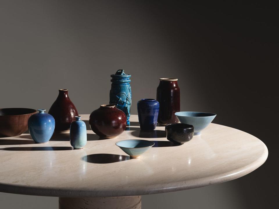 a set of colorful ceramic dishes and vessels