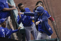 Toronto Blue Jays' Danny Jansen, front right, is greeted by teammates after hitting a two-run home run against the Baltimore Orioles during the fourth inning of the first game of a baseball doubleheader, Saturday, Sept. 11, 2021, in Baltimore. (AP Photo/Julio Cortez)
