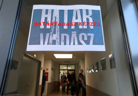 Hungarian border hunter recruits come out from their classes as a sign reading "Border Hunter" is seen on the door, during a training at the border crossing point in Barcs, Hungary March 8, 2017. REUTERS/Laszlo Balogh