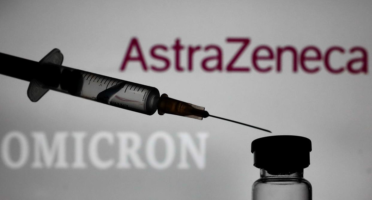 Medical syringe is seen with AstraZeneca logo and 'omicron' sign displayed in the background in this illustration photo taken in Krakow, Poland on November 29, 2021. (Photo by Jakub Porzycki/NurPhoto)
