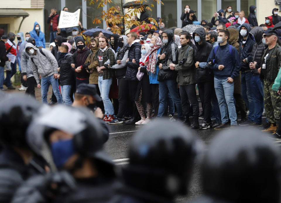 Belarusian opposition supporters block a street during a rally to protest the official presidential election results in Minsk, Belarus, Sunday, Oct. 11, 2020. Belarus' authoritarian president Alexander Lukashenko on Saturday visited a prison to talk to opposition activists, who have been jailed for challenging his re-election that was widely seen as manipulated and triggered two months of protests. (AP Photo)