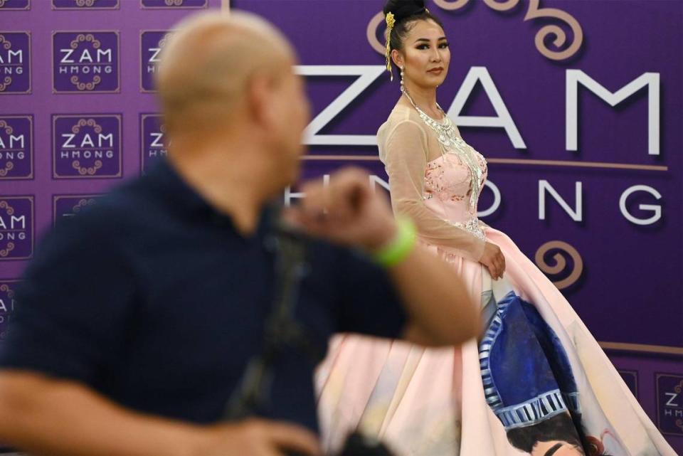 A photographer instructs a model to pose at the 2023 Hmong American Day celebration hed at The Fresno Center Saturday, May 13, 2023 in Fresno. The event which included a ramen bar, music and fashion featured a proclamation by Fresno Mayor Jerry Dyer recognizing Hmong American Day and the history and contributions of the Hmong to the Valley.