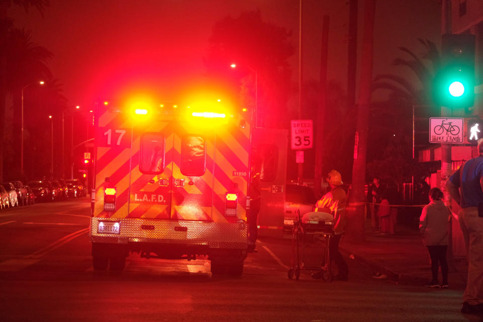 Emergency personnel work at the scene of a fireworks explosion in Los Angeles on Wednesday, June 30, 2021. A cache of illegal fireworks seized at a South Los Angeles home exploded, damaging nearby homes and injuring several people, authorities said. (AP Photo/Ringo H.W. Chiu)