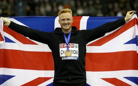 Greg Rutherford poses for photographers after winning the Men's Long Jump during day one of the SPAR British Indoor Athletics Championships at Arena Birmingham - Credit: PA