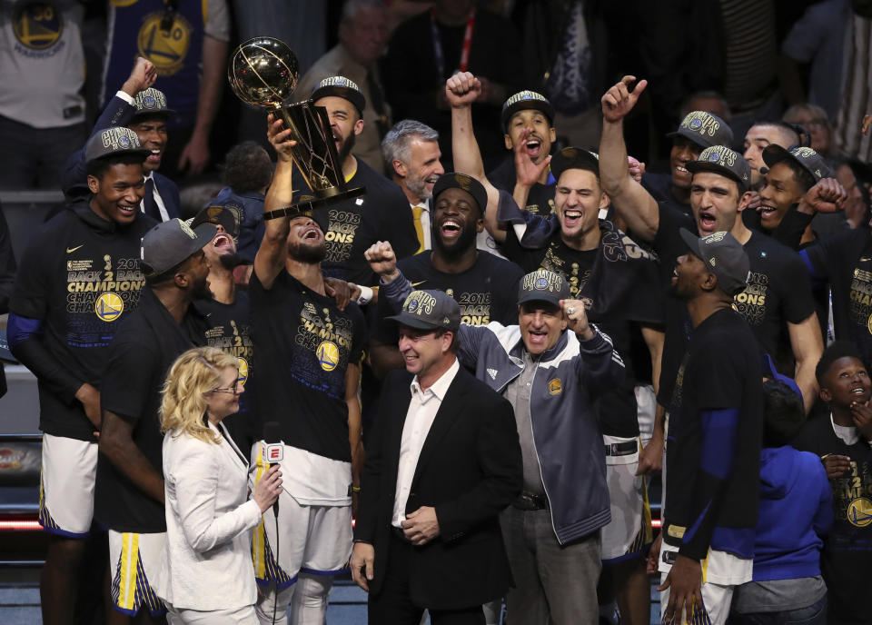 FILE - In this Friday, June 8, 2018, file photo, the Golden State Warriors celebrate after defeating the Cleveland Cavaliers 108-85 in Game 4 of basketball's NBA Finals to win the NBA championship, in Cleveland. The three-time NBA champion Golden State Warriors are the fourth team to be honored as Sports Illustrated’s Sportsperson of the Year, the magazine announced Monday, Dec. 10, 2018. (AP Photo/Carlos Osorio, File)