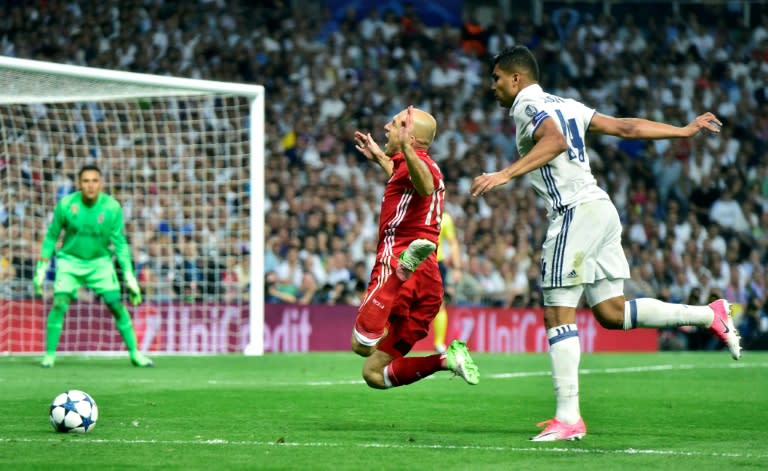 Bayern Munich's midfielder Arjen Robben (L) is fouled by Real Madrid's Brazilian midfielder Casemiro during the UEFA Champions League quarter-final second leg football match Real Madrid vs FC Bayern Munich on April 18, 2017