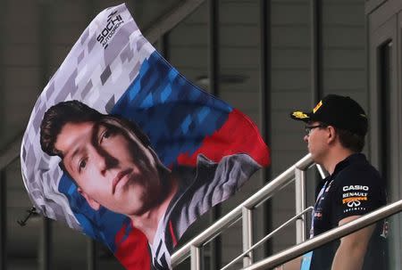 Formula One - Russian Grand Prix - Sochi, Russia - 30/4/16 - A spectator looks at a flag with the picture of Red Bull F1 driver Daniil Kvyat of Russia. REUTERS/Yuri Kochetkov/Pool