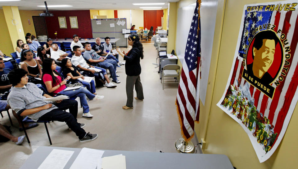 A poster with an image of Cesar Chavez and the motto "Si se puede (Yes we can") is seen at an orientation seminar for illegal immigrants, to determine if they qualify for temporary work permits, at the Coalition for Humane Immigrant Rights of Los Angeles (CHIRLA), in Los Angeles, Thursday, Sept. 20, 2012. Schools and consulates have been flooded with requests for documents since President Barack Obama’s administration said many young illegal immigrants may be eligible for two-year renewable work permits. The new policy has left schools and consulates scrambling for quick fixes ranging from new online forms, reassigned workers and extended hours. (AP Photo/Reed Saxon)