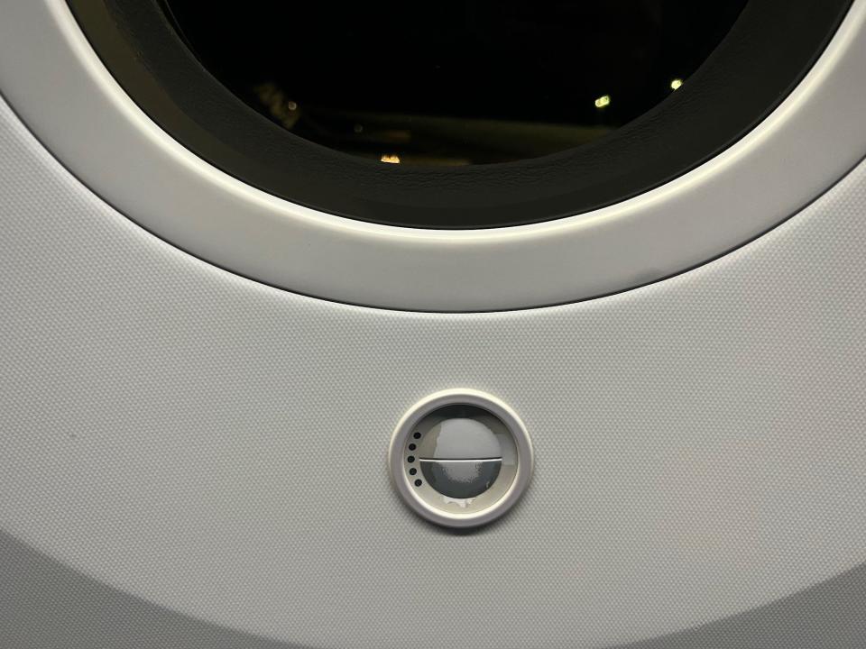 The button below the window to dim the shades.