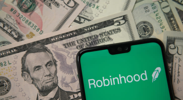 Robinhood stocks: app logo seen on smartphone on US dollar banknotes