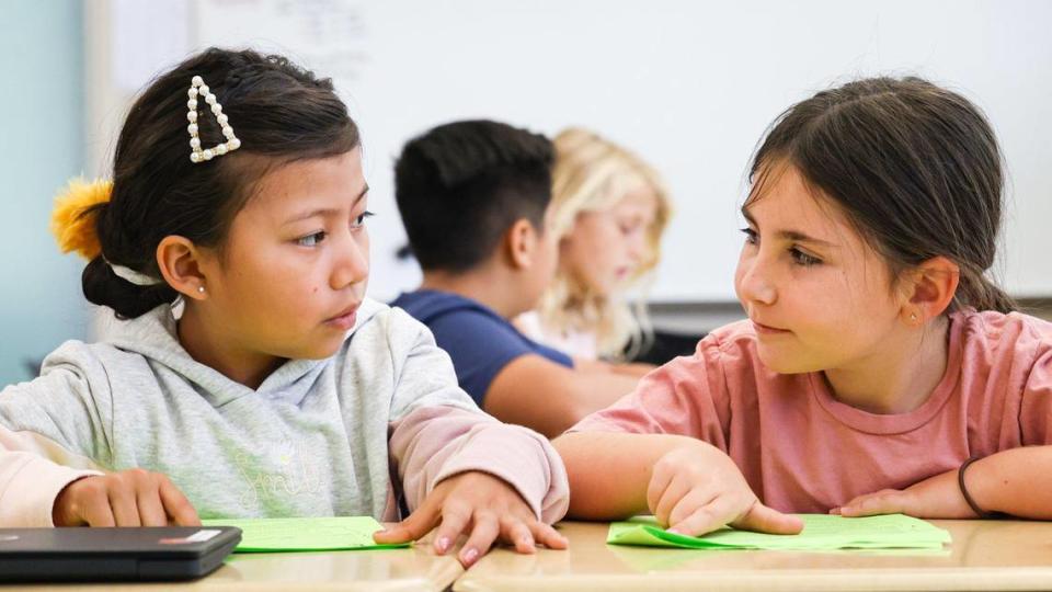 From the left, Carrisa Plains Elementary School third-graders Lilibeth Romero Sanchez and McKinley Twisselman partner read, taking turns speaking sentences. David Middlecamp/dmiddlecamp@thetribunenews.com