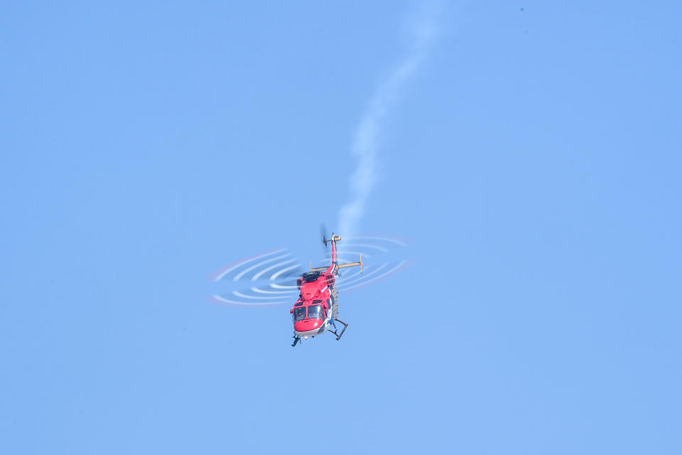 An Indian Air Force (IAF) Advanced Light Helicopter (ALH) 'Sarang' team member performs during the 88th Air Force Day parade at Hindon Air Force station in Ghaziabad on October 8, 2020. (Photo by Money SHARMA / AFP) (Photo by MONEY SHARMA/AFP via Getty Images)