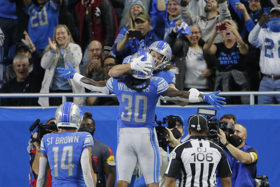 Detroit Lions tight end T.J. Hockenson, rear, celebrates his 17-yard pass reception for a touchdown with teammate running back Jamaal Williams (30) during the second half of an NFL football game against the Chicago Bears, Thursday, Nov. 25, 2021, in Detroit. (AP Photo/Duane Burleson)