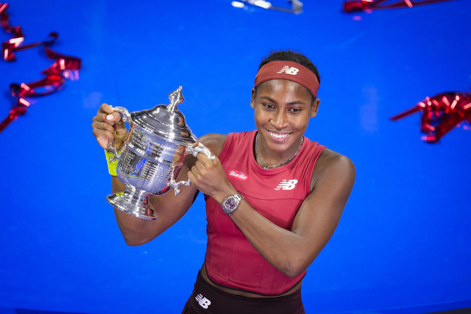 Coco Gauff, of the United States, poses for photographs after defeating Aryna Sabalenka, of Belarus, at the women's singles final of the U.S. Open tennis championships, Saturday, Sept. 9, 2023, in New York. (AP Photo/John Minchillo)