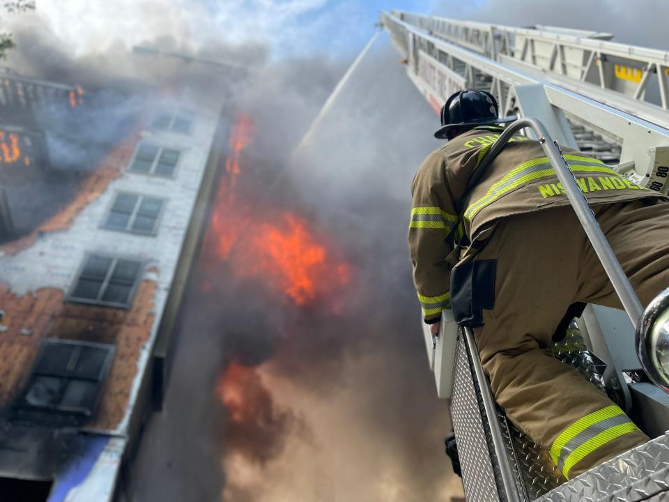Crews battle a four-alarm fire that broke out in a construction zone on Thursday in a Charlotte, N.C., suburb, the Charlotte Fire Department said.