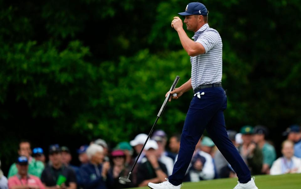 Bryson DeChambeau waves after making a putt on the first hole during the first round at the Masters