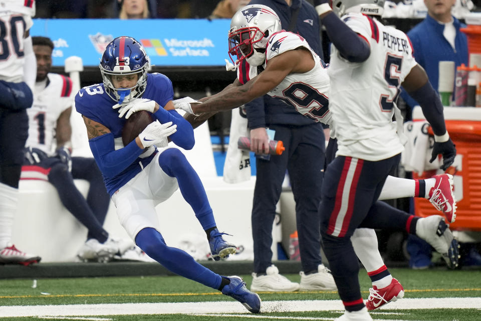 New York Giants wide receiver Jalin Hyatt (13) makes a catch against New England Patriots cornerback J.C. Jackson (29) during the third quarter of an NFL football game, Sunday, Nov. 26, 2023, in East Rutherford, N.J. (AP Photo/Seth Wenig)