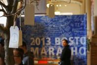 A peace sign is seen on a message tree as visitors look at artefacts in a public exhibition of objects and mementos left at the makeshift memorials that emerged in the aftermath of the Boston Marathon Bombings in Boston, Massachusetts, April 7, 2014. REUTERS/Dominick Reuter